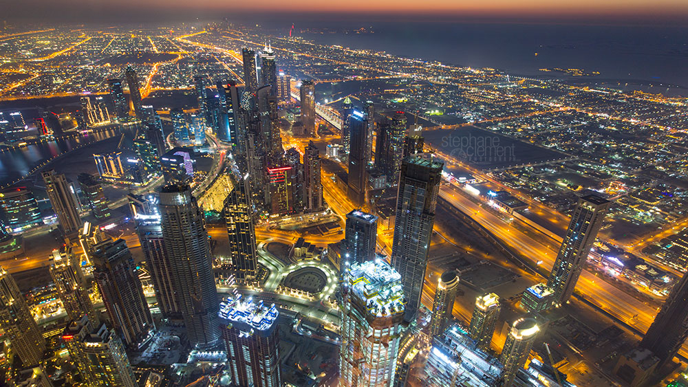 Dubai by night: building, roads and lifestyle with colorful ligh