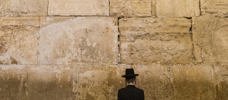 Jewish men praying at the sacred Wailing Wall, Western Wall, Jerusalem, Israel.