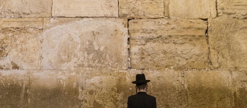 Jewish men praying at the sacred Wailing Wall, Western Wall, Jerusalem, Israel.